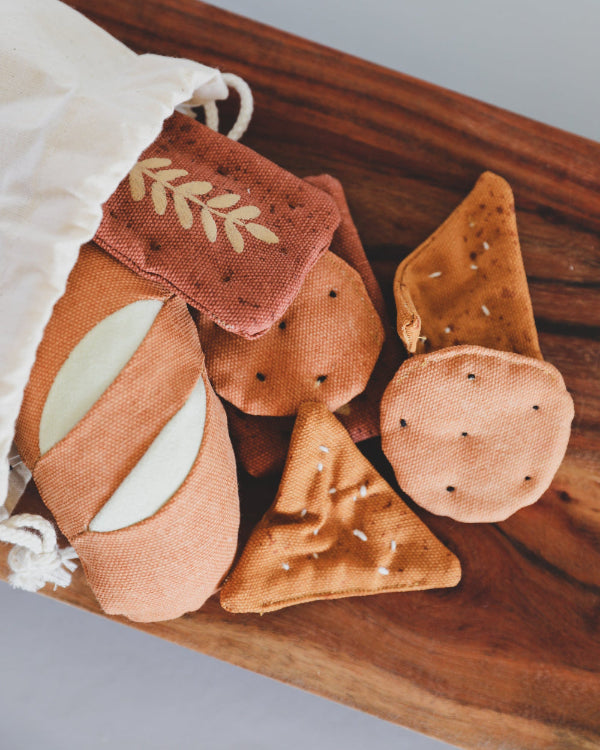 Seven-piece Danish handcrafted bread and crackers play food set with realistic textures and embroidered details
