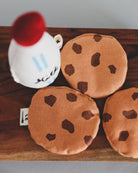Premium textile play food showing hand-embroidered cookie details and authentic milk bottle design