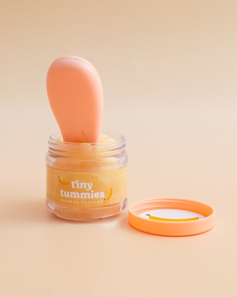 Realistic play kitchen accessories featuring Tiny Harlow banana custard doll bottle