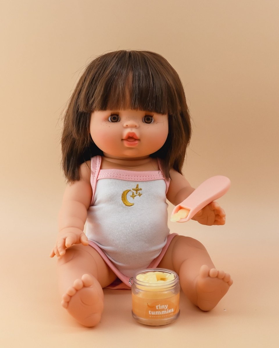 Detailed play kitchen accessories featuring Tiny Harlow banana custard doll bottle