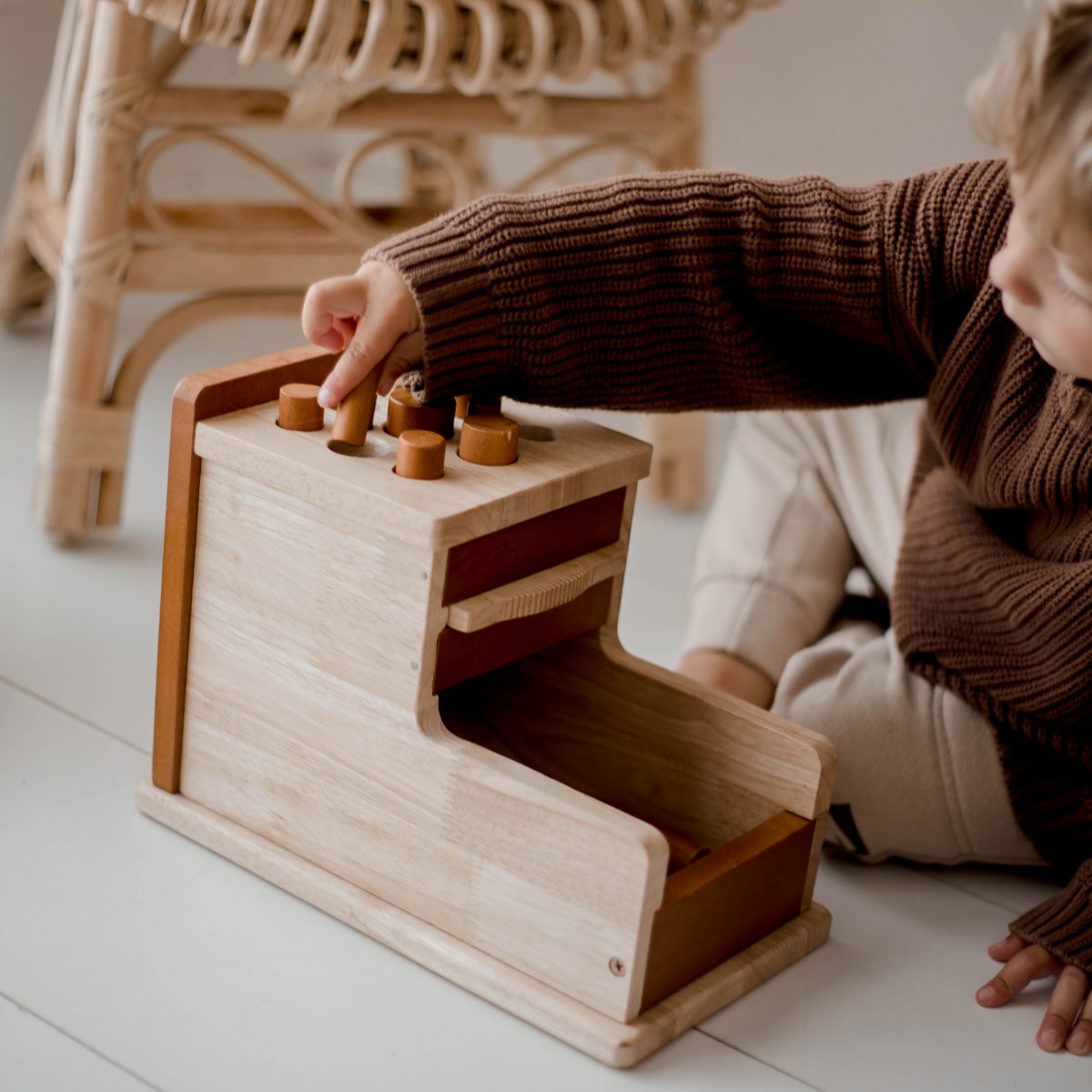 Child playing with wooden Montessori toy