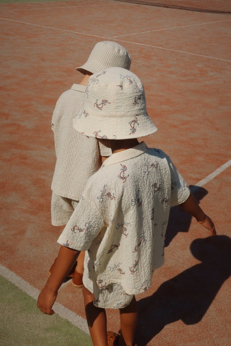 2 Boys Wearing a Bucket Hat in the Sun