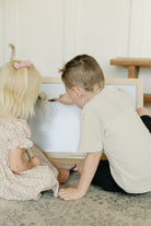 2 Children on Tabletop Easel