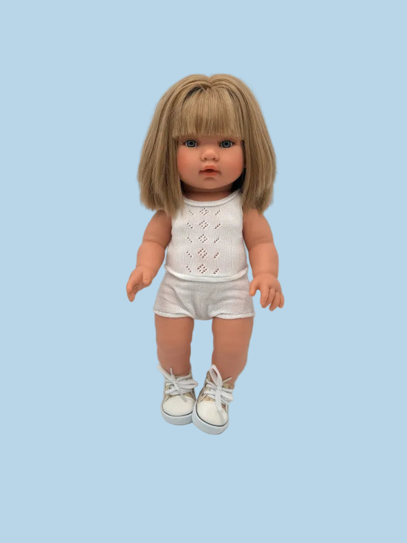 Doll wearing a white outfit with a plain background