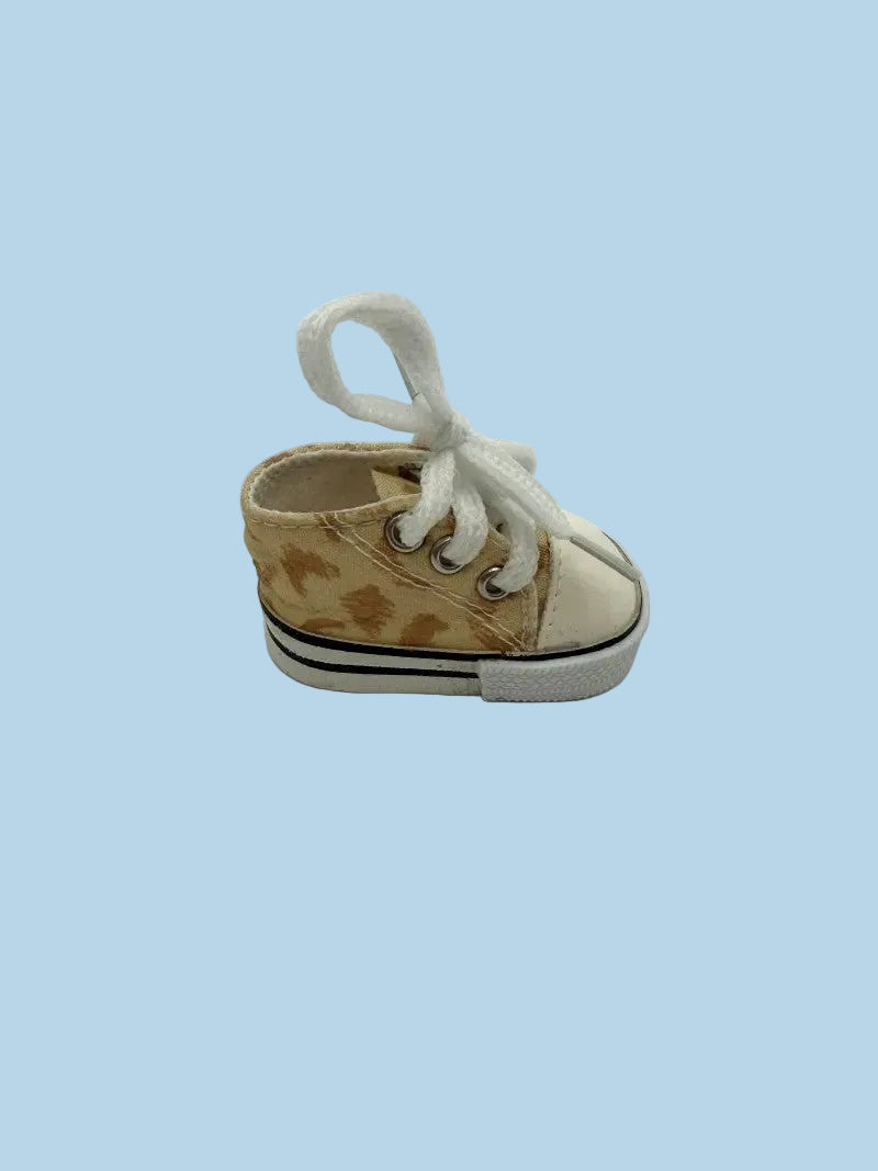 Small brown and white sneaker on a light blue background