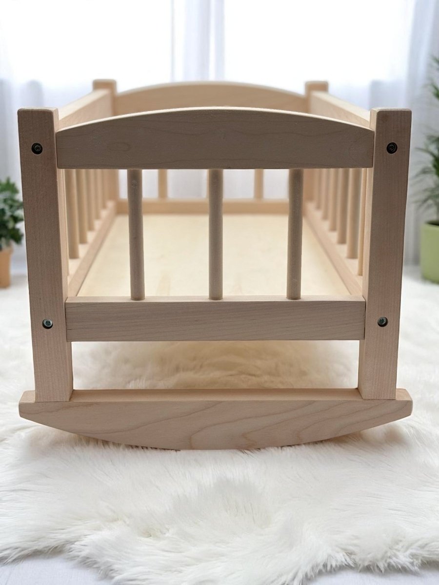 Heirloom quality wooden doll cradle with safety tested birch wood construction for nurturing play