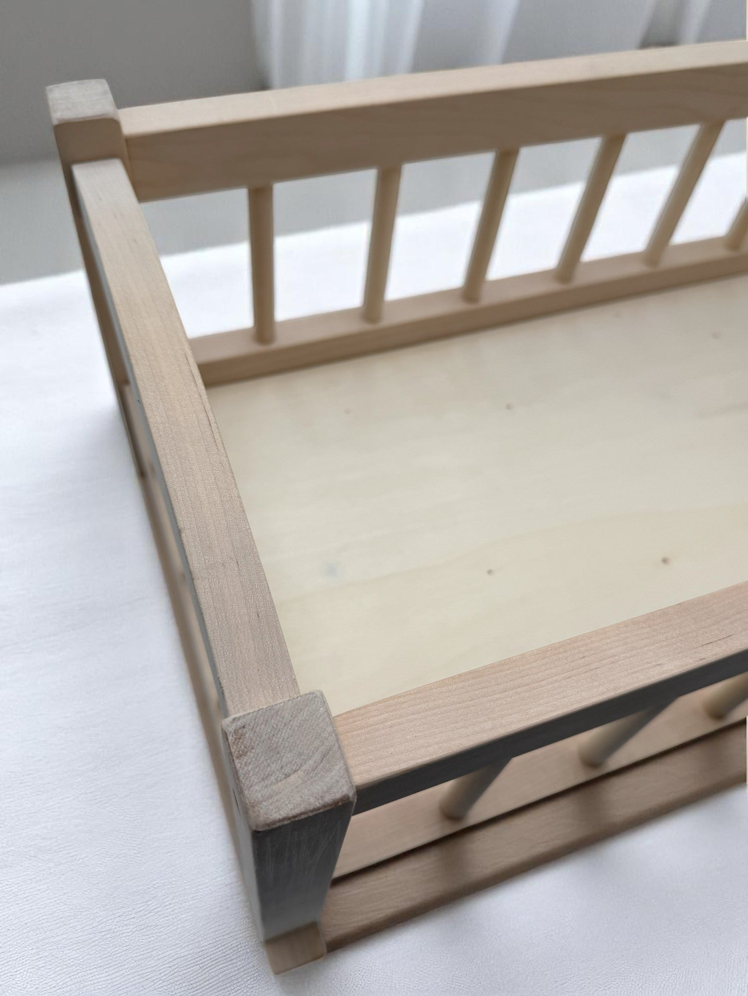 Wooden baby doll bed with spacious interior dimensions for realistic doll care and pretend play