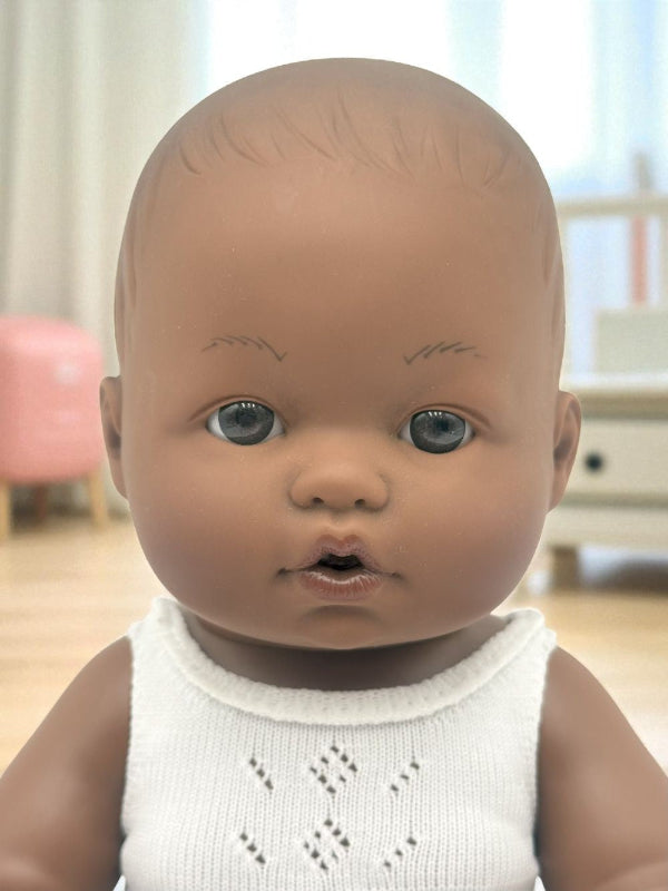 Close-up of Cairo doll's lifelike face with expressive brown eyes