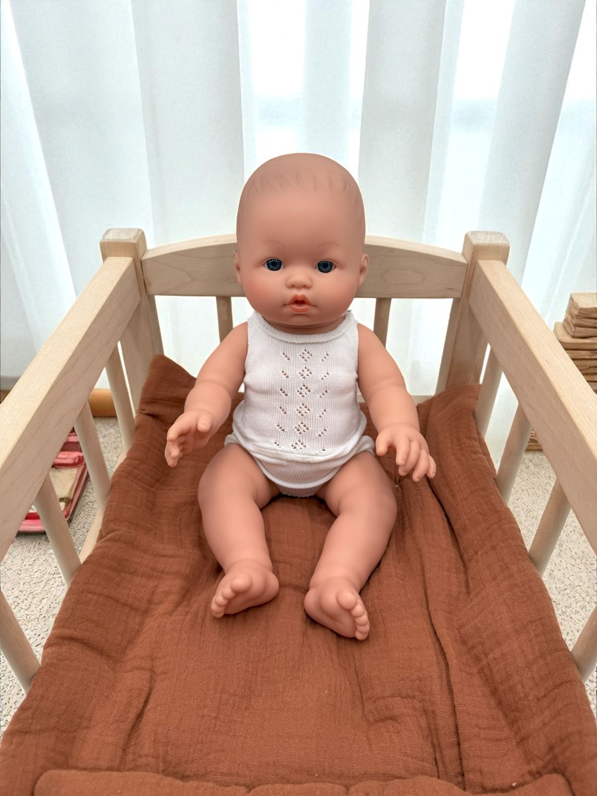 Blue-eyed realistic baby boy doll for developmental playroom activities
