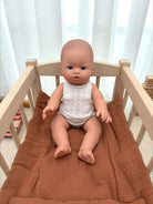 Blue-eyed realistic baby boy doll for developmental playroom activities