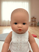 Close-up of Troy doll's lifelike face with expressive blue eyes