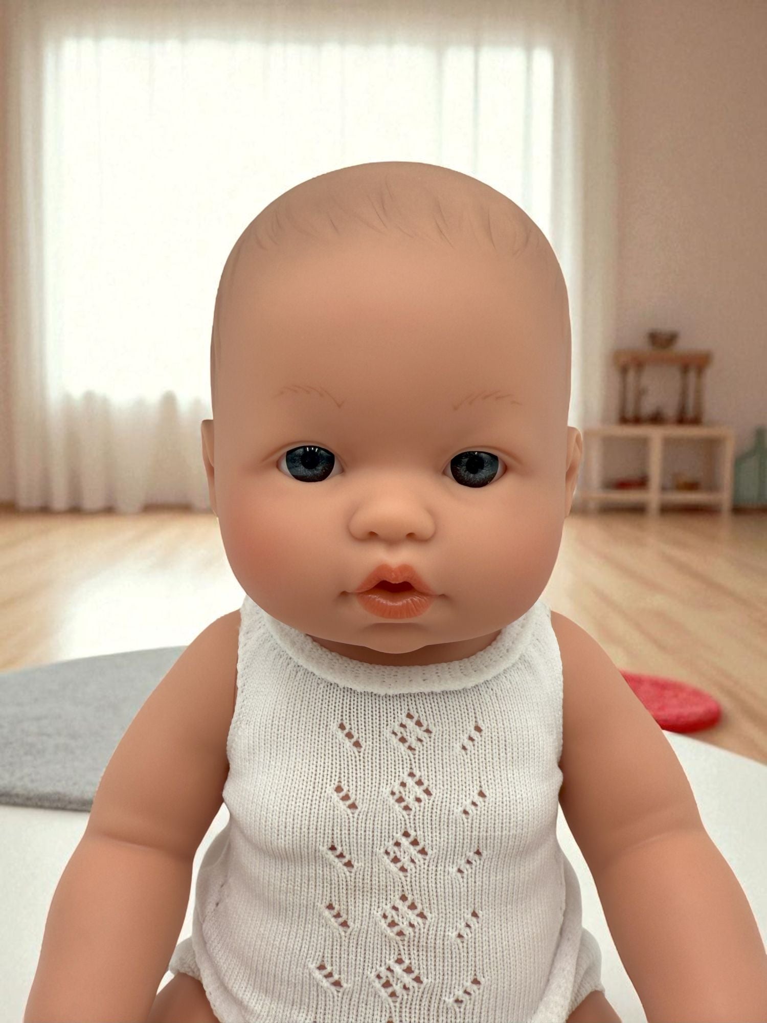 Close-up of Troy doll's lifelike face with expressive blue eyes