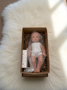 Fully clothed bald baby boy doll with blue eyes for imaginative care play
