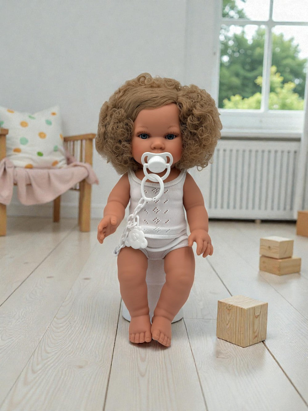 Artisan crafted girl doll showing bouncy blonde curls and sweet curious expression