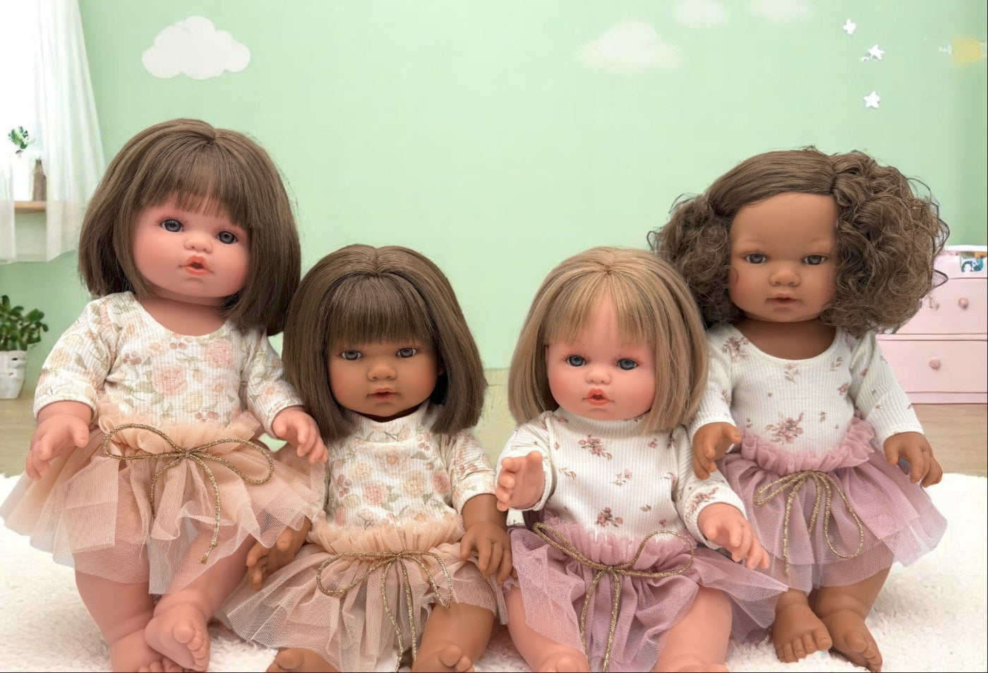 Four cute lifelike dolls in a playroom