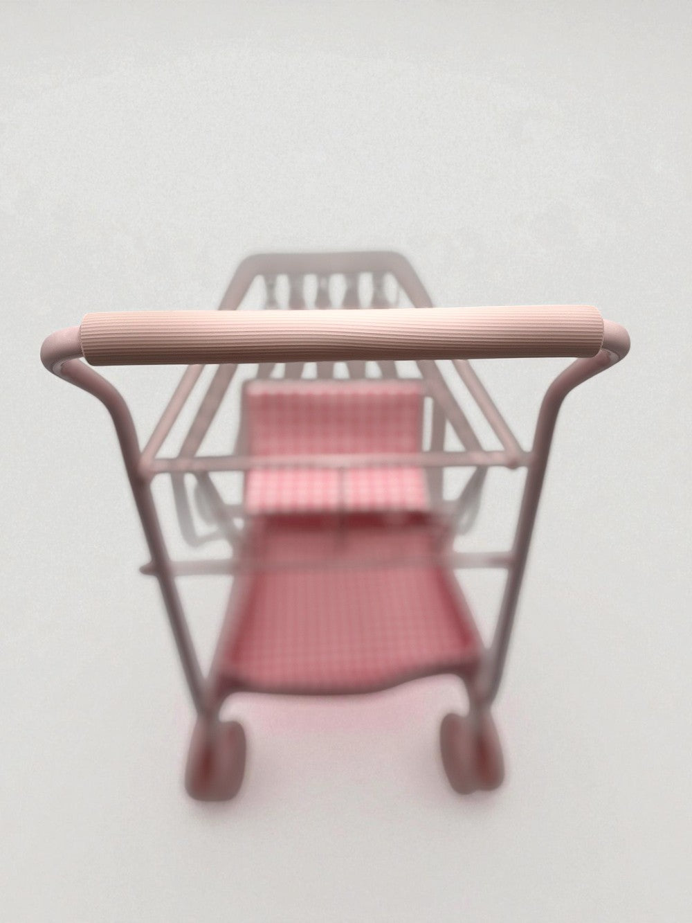 Comfortable EVA foam handle on pink gingham shopping cart designed for small hands during pretend play adventures