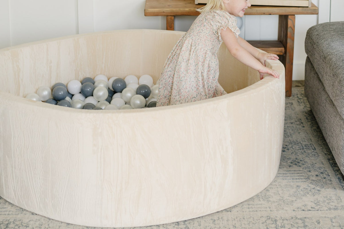 Child Grabbing Ball Pit