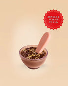 Chocolate cereal toy and a spoon on a beige background.