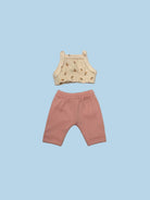 A two-piece baby outfit set laid flat on a light gray background, featuring a cream-colored sleeveless top with a small brown floral pattern and matching pink ribbed shorts.