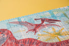 Jigsaw puzzle with dinosaur design on a yellow background