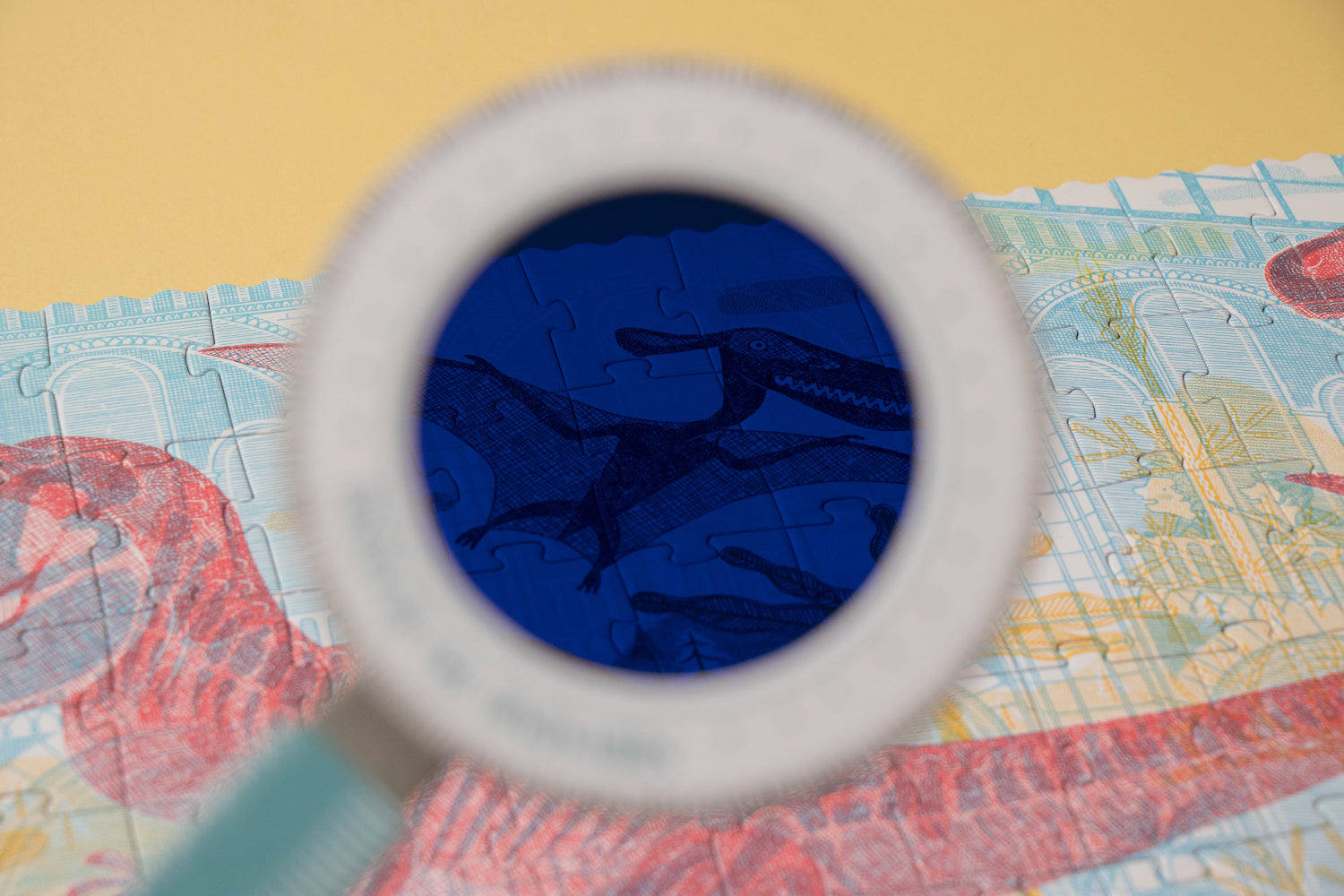 Close-up of a blue object through a magnifying glass on a colorful background
