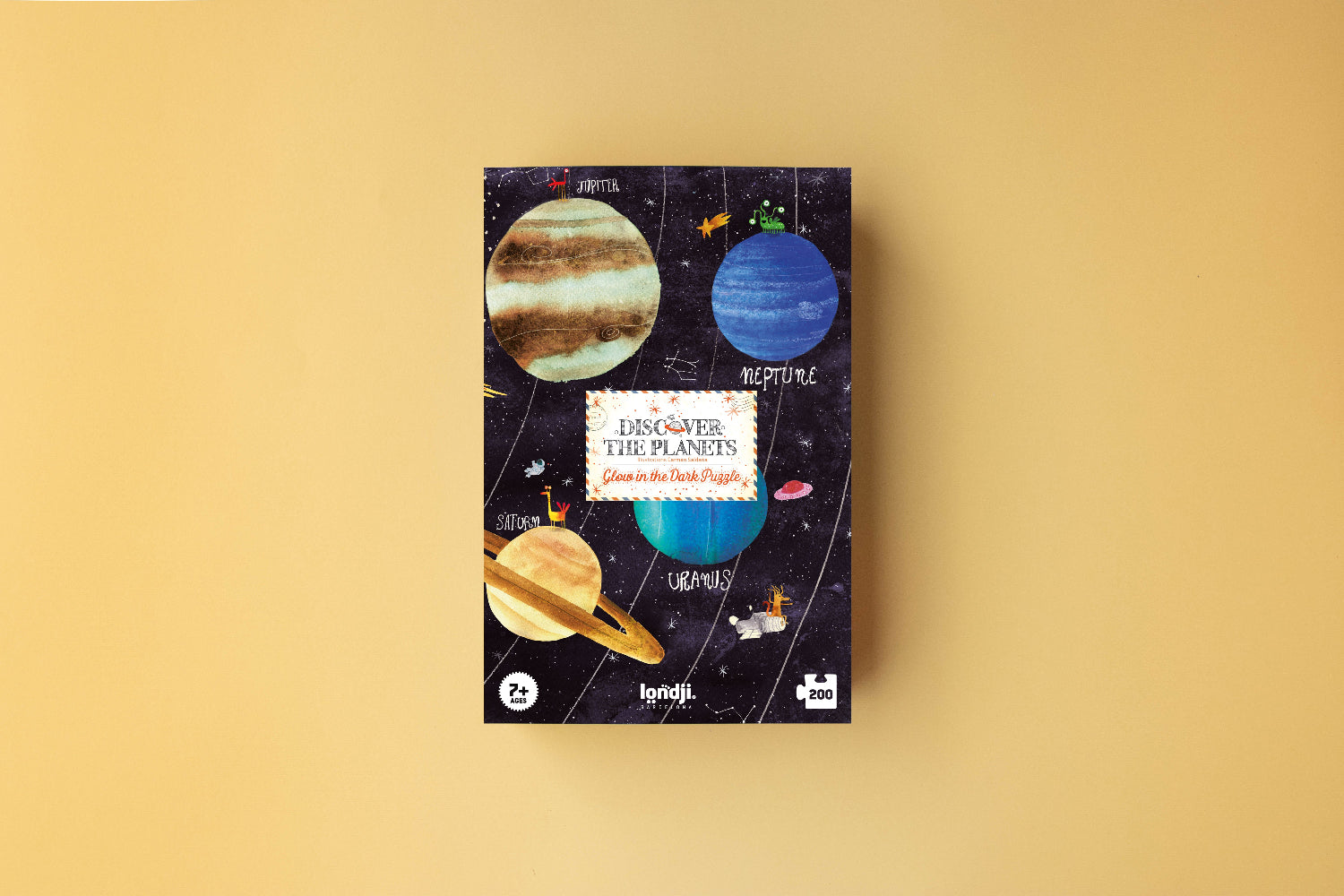 Jigsaw puzzle box with planet illustrations on a beige background