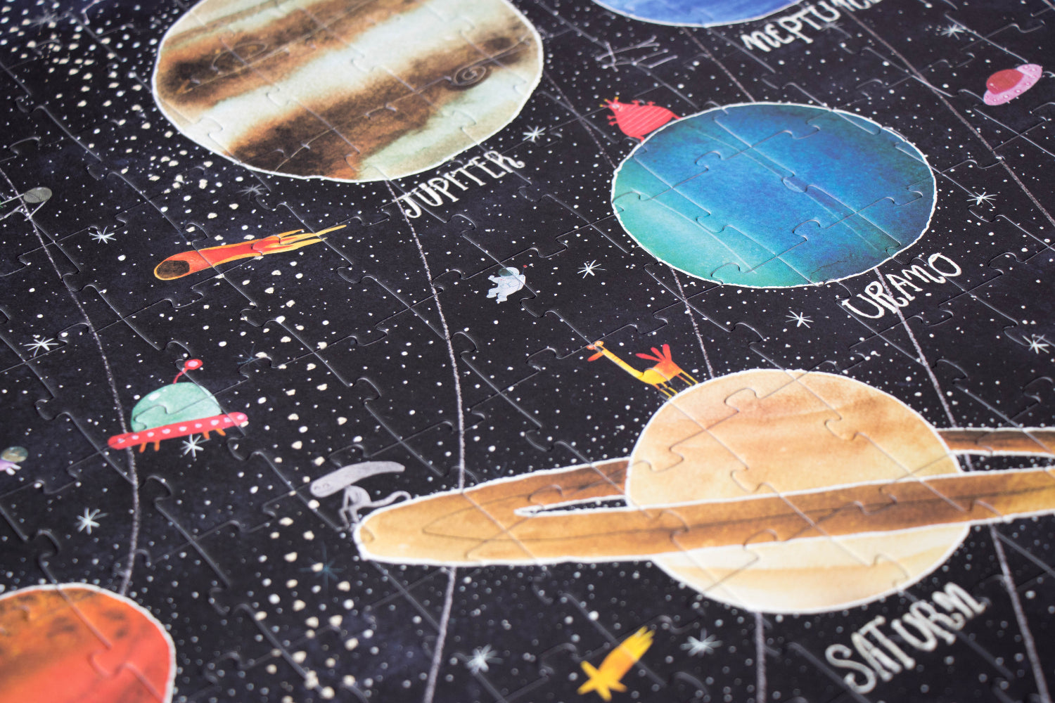 Children's space-themed puzzle with illustrations of planets and stars on a dark background.