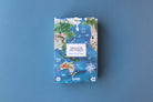 Jigsaw puzzle box with world map design on a blue background