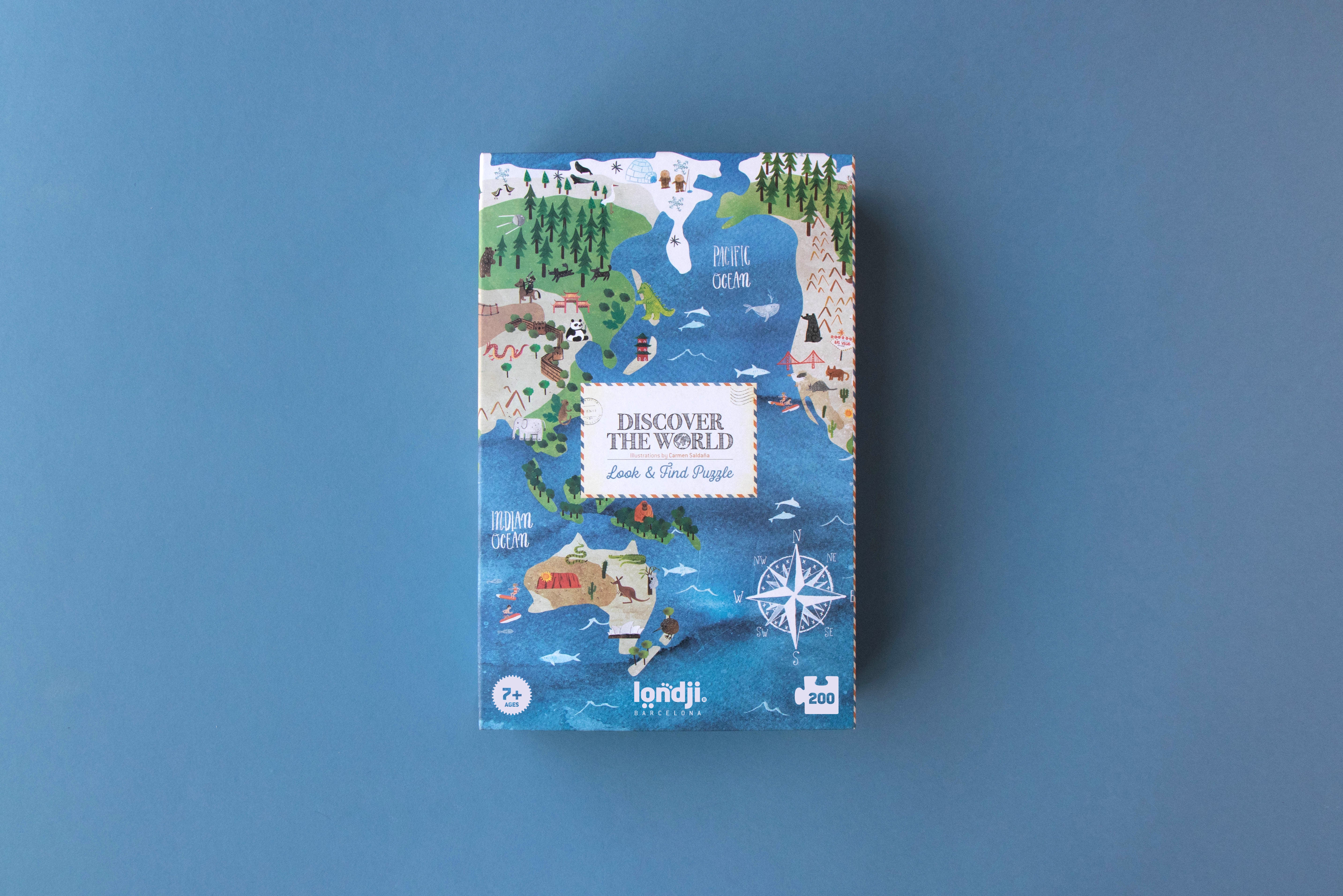 Jigsaw puzzle box with world map design on a blue background