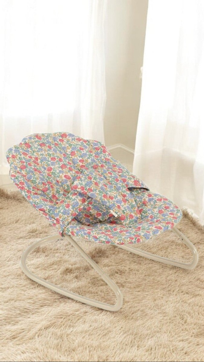 Playroom-designed baby doll bouncer with decorative elements and comfort features
