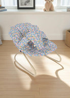 Fleur Rosier doll bouncer with blue floral print fabric seat featuring botanical garden design and champagne metal frame