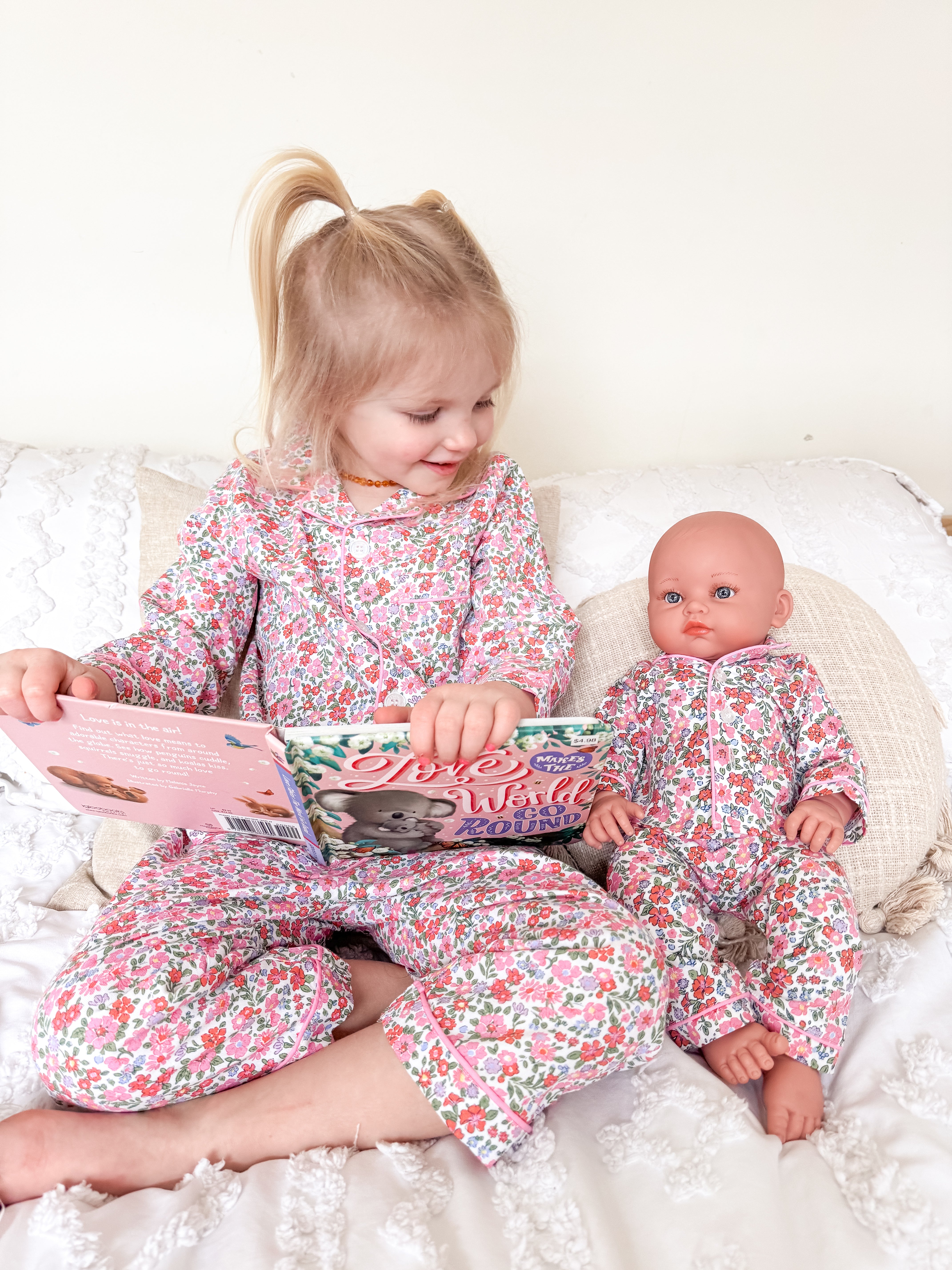 Girl and doll wearing floral pajamas