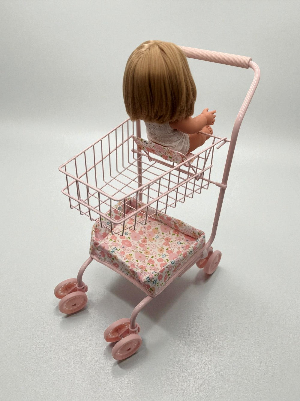 13-inch doll seated comfortably in floral cart showing perfect proportions for realistic shopping play
