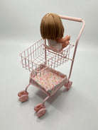 13-inch doll seated comfortably in floral cart showing perfect proportions for realistic shopping play