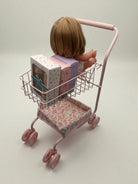 Upper wire basket filled with toy groceries demonstrating generous storage space for shopping adventures