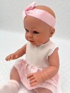 European-quality 18" girl doll in pink dress and white ribbed top with satin ribbon