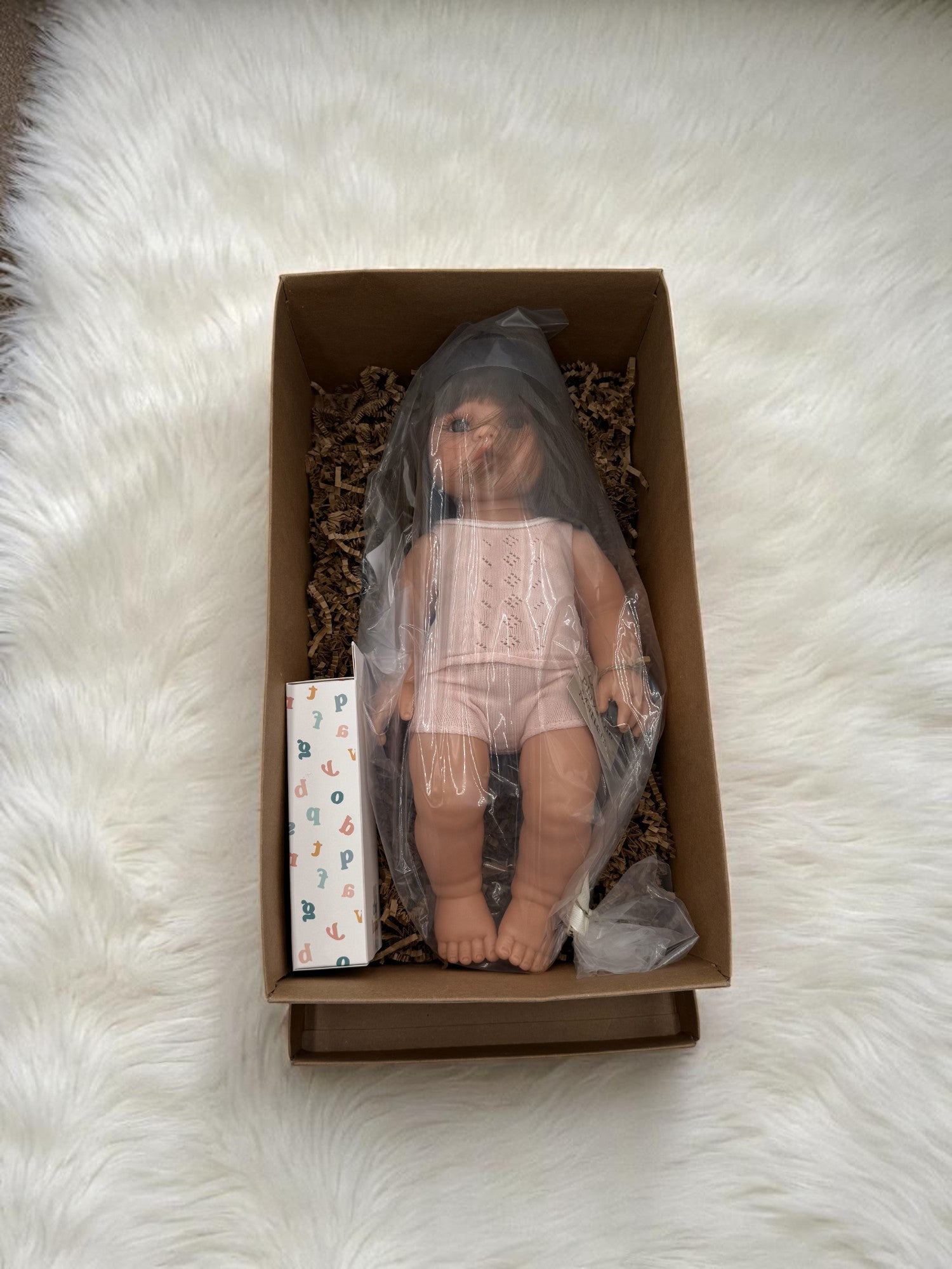 Lifelike Milan baby doll with bob haircut ideal for children's playroom emotional development activities