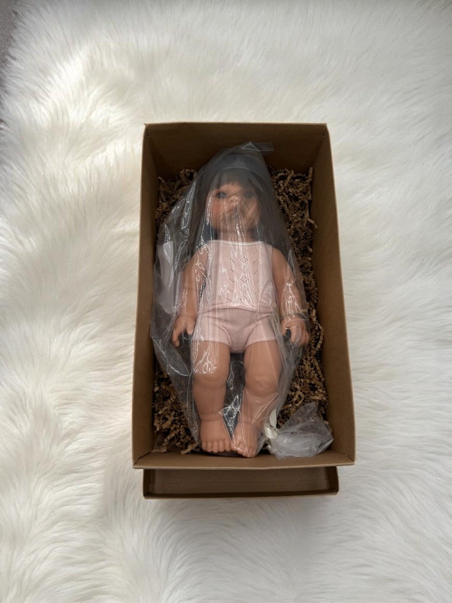 Realistic doll Milan with brunette straight hair wearing pink ribbed pajama set for screen-free play