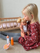 Girl kissing doll