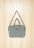 Front view of green and white checkered doll bag with cherry embroidery detail