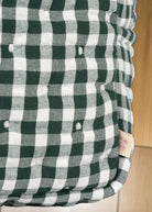 Side angle of structured canvas doll care bag in classic green check pattern