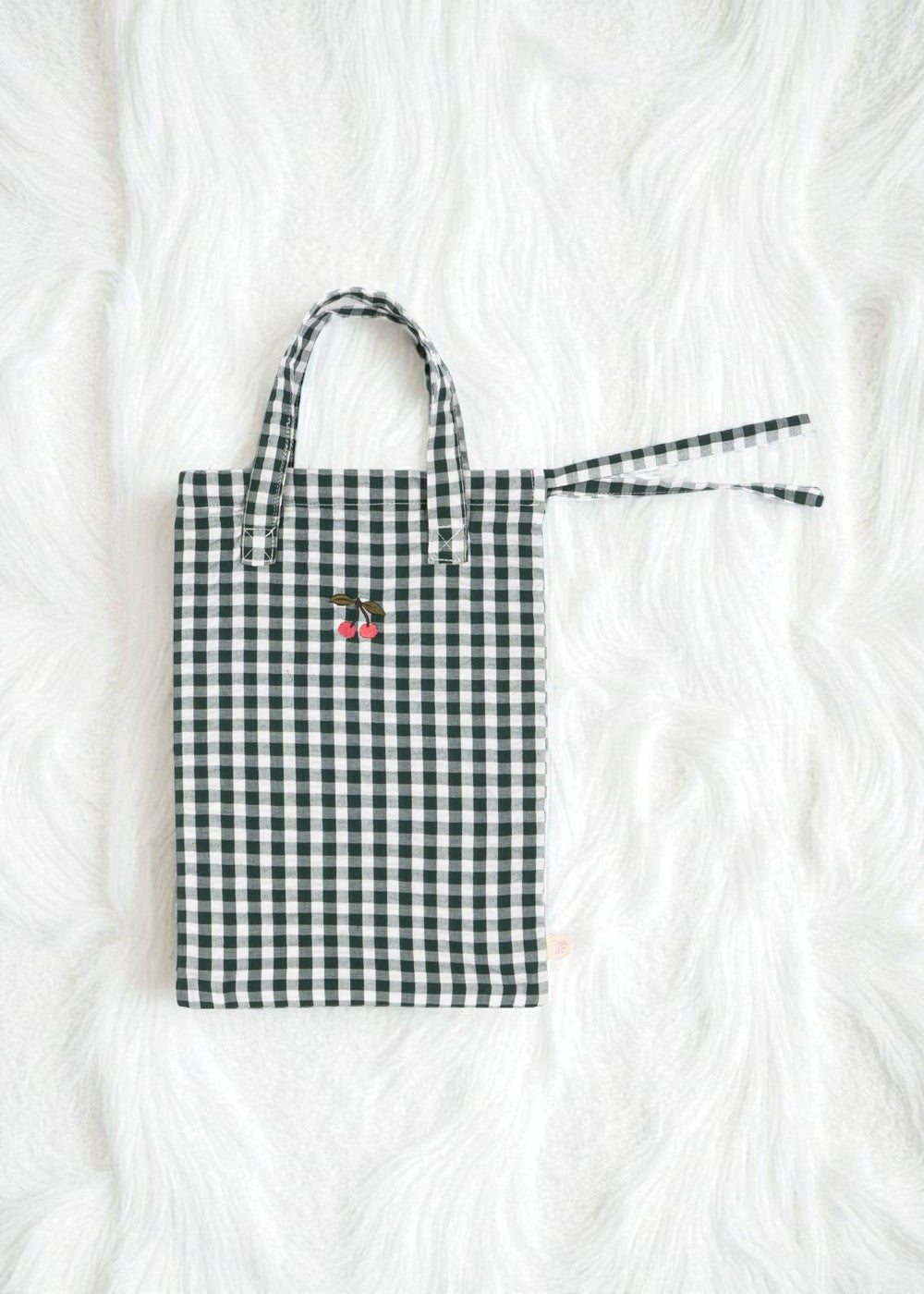 Premium construction detail showing button-tufted craftsmanship of green check doll bedding set