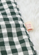 Matching green gingham pillow with plush filling showing quality construction and country cottage pattern detail