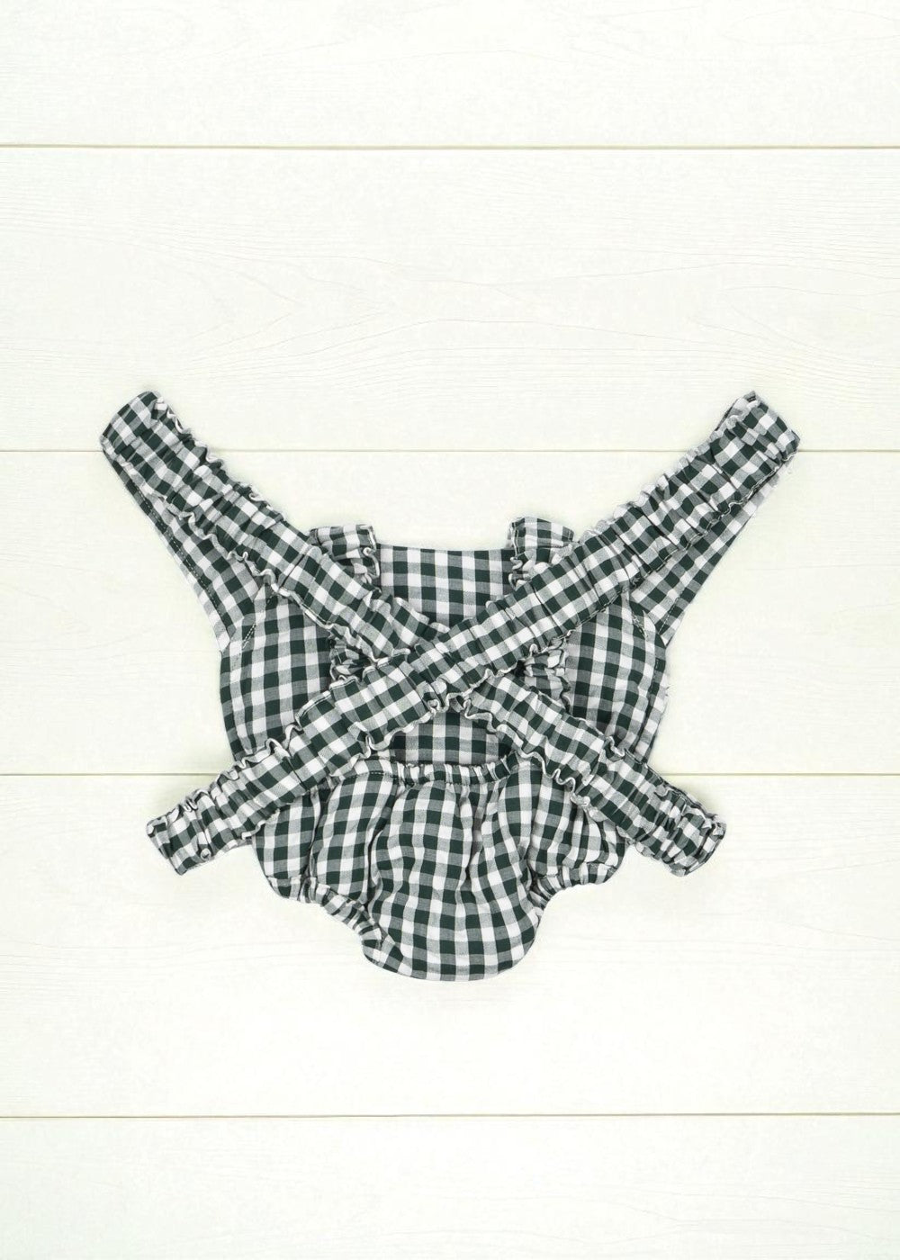 Back view of green gingham doll carrier showing comfortable strap system and complete pattern coverage