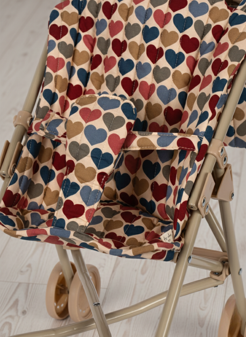 Foldable chair with a colorful heart-patterned cover on a light floor.