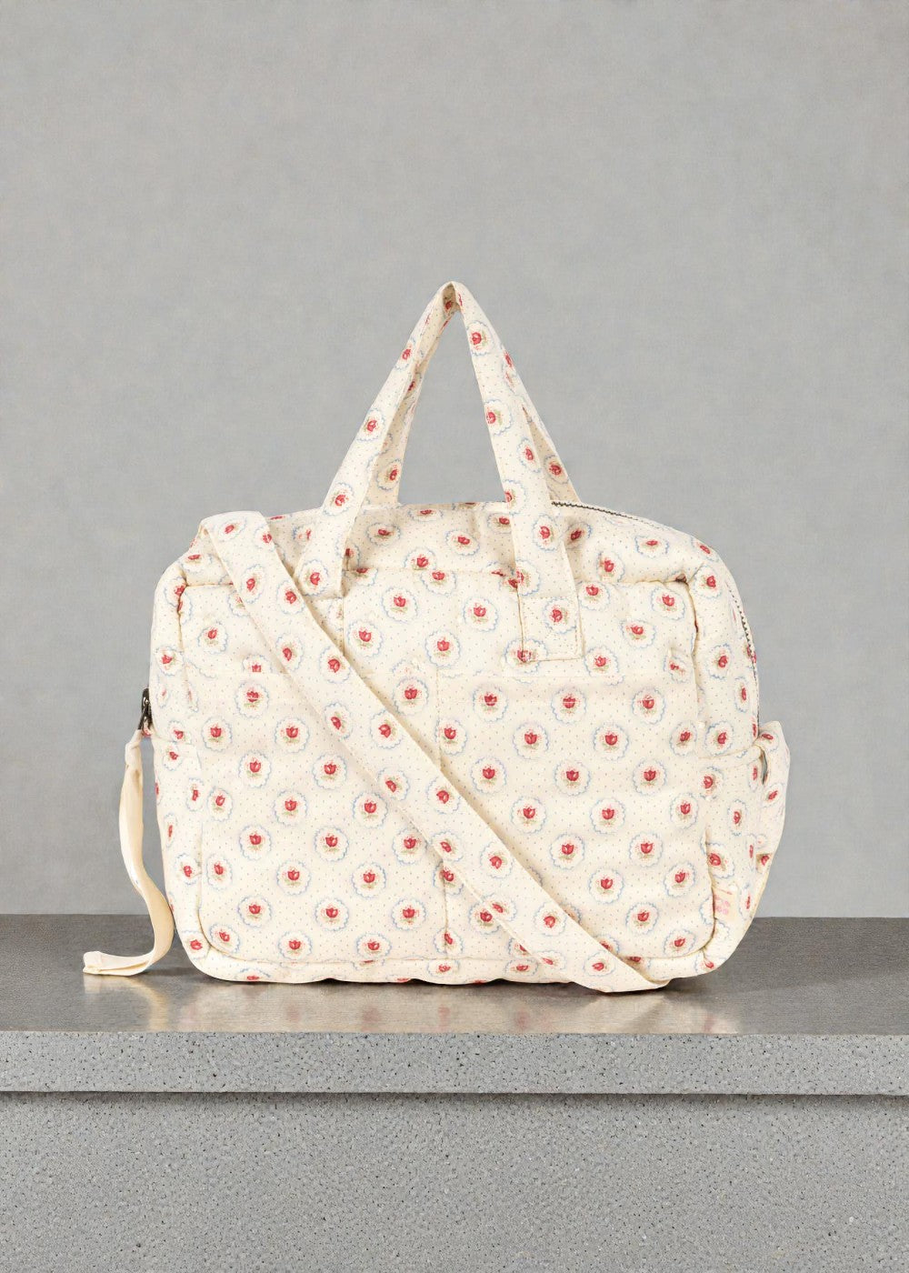 Konges Sløjd Mirage doll diaper bag with red tulip print and dual carry options