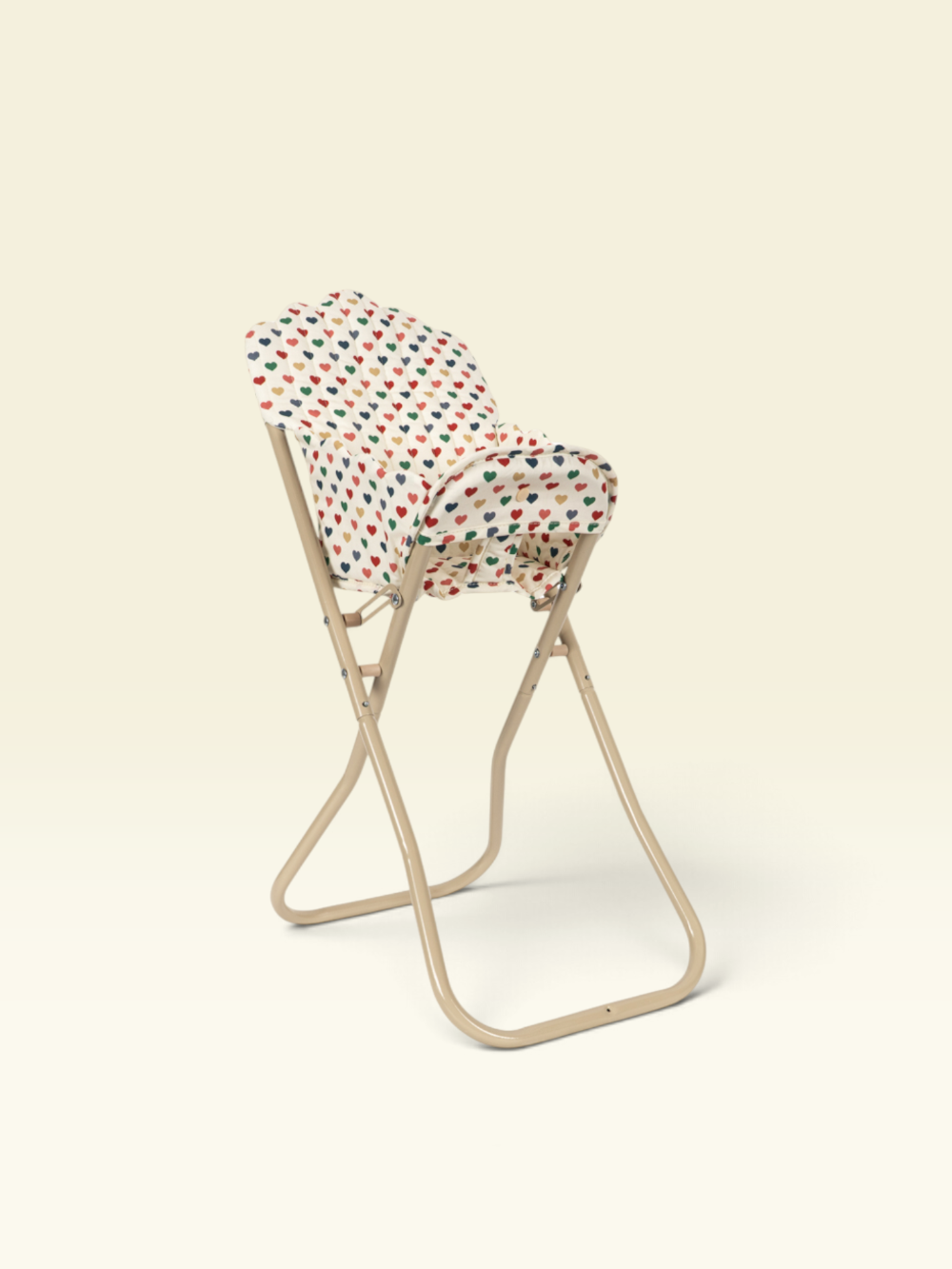 A beige folding chair with a white fabric seat cushion covered in a colorful red, green, and blue polka-dot pattern, set against a solid cream background.