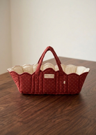 Overhead view of quilted doll bassinet showing soft padded interior and reinforced carry handles