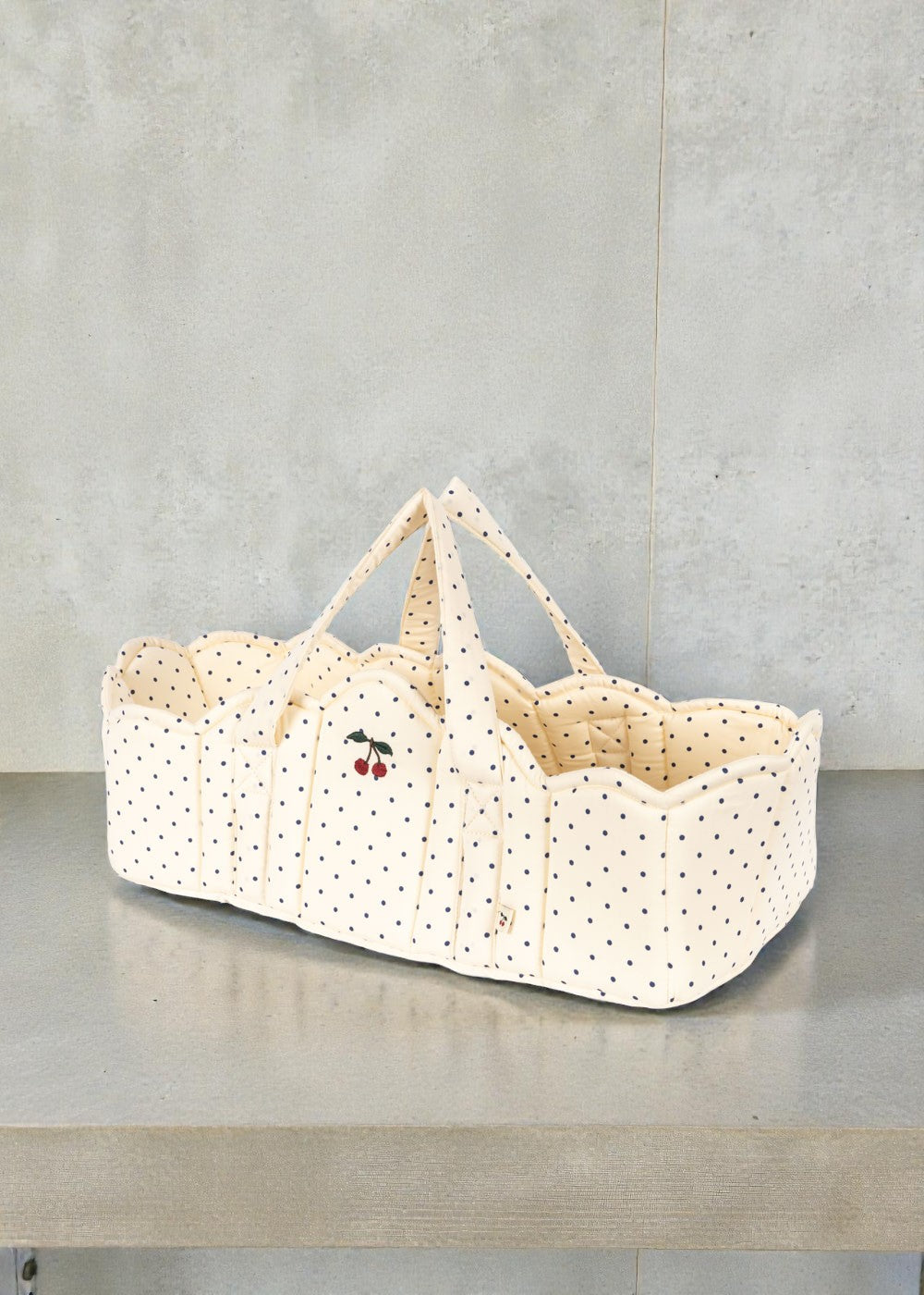 Konges Sløjd Estate Dot doll bassinet with navy polka dots and cherry embroidery detail