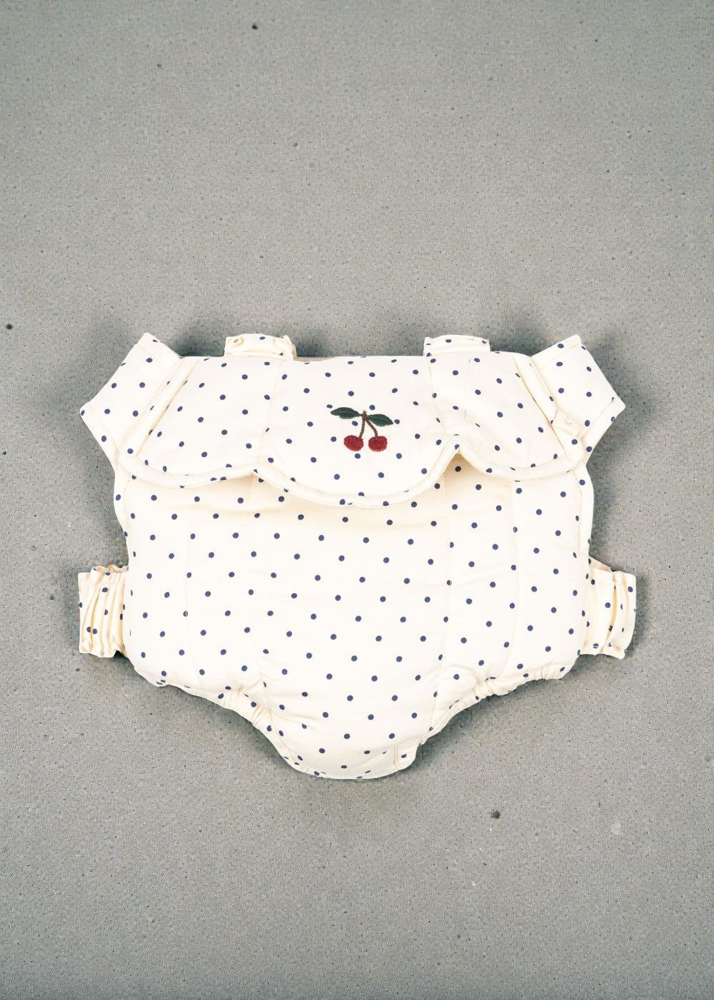 Konges Sløjd Estate Dot doll carrier with navy polka dots and cherry embroidery